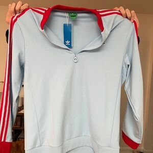 NWT Adidas golf originals quarter zip. Clear sky with red three stripes.